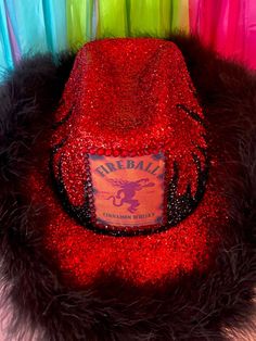 a red hat sitting on top of a pile of colorful streamers