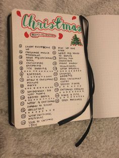 an open christmas planner sitting on top of a bed