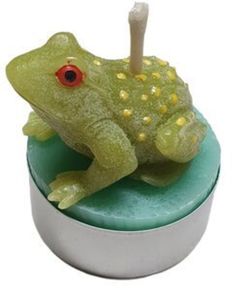 a green frog sitting on top of a white container