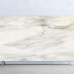 a white marble counter top sitting in a room