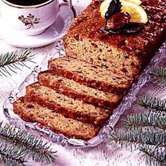 a loaf of bread sitting on top of a table next to a cup of coffee