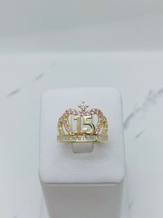 14k gold ring sweet 15 quinceañera crown    ❤️ Fine jewelry  ❤️ Size 8 ❤️ 100% 14k Yellow Gold with white and pink cubic zirconia  ❤️ Includes a box  Check out my other jewelry  ❤️ Anillo de quinceañera de 14k de oro sólido  ❤️ Corona de Quince años ❤️ Joyeria fina  ❤️ Esta sortija es tamaño 8 ❤️ Incluye Cajita ♥️ Piedra blanca y rosado en oro dorado   Vea mi página para ver más joyas SKU 042944 15 Rings Quinceanera Emerald Green, Quince Rings Gold, Quinceanera Rings, Quince Rings, Quince Jewelry, Betty Boop Jewelry, Heart Tiara, Rose Gold Quince, Quinceanera Crown