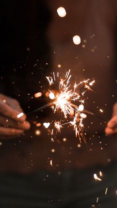 a person holding a sparkler in their hands