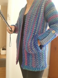 A woman wearing a multi-colored crochet cardigan. Crochet Scrap Cardigan Pattern Free, Crochet Cardigans For Women Free Pattern, Crocheted Cardigans Free Patterns, Free Sweater Pattern, Crochet Sweater Pattern Free Women, Crochet A Cardigan, Wearable Crochet, Classic Preppy Style, Cardigan Sweater Pattern