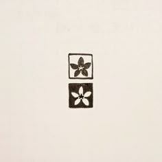 a black and white drawing of a flower in a square with two squares on it