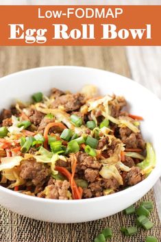 an egg roll bowl in a white bowl with green onions and carrots on the side