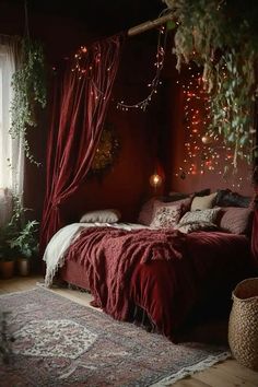 a bed in a room with red curtains and lights hanging from the ceiling above it