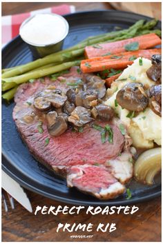 a plate with meat, potatoes and asparagus on it