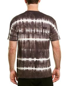 a man wearing a black and white tie - dye t - shirt, back view