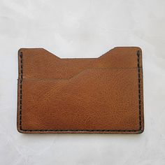 Minimalist Leather Wallet *Slim or minimalist wallet, made from hand-stitched full grain leather cowhide. *Dimensions 2.65 x 3.85 x 0.15 inches. *Please note, Wallet is natural leather and will require break-in/use to become soft and pliable. Natural leather may also have minor variations in color and blemishes. Natural leather is very durable and will last a very long time. Hand-stitched Leather Card Holder For Everyday Use, Brown Minimalist Card Holder With Rfid Blocking, Minimalist Leather Bifold Card Holder, Minimalist Brown Rectangular Card Holder, Everyday Leather Card Holder With Smooth Grain, Minimalist Leather Wallet For Everyday Carry, Handmade Minimalist Brown Wallet, Everyday Brown Vegetable-tanned Wallet, Minimalist Brown Card Holder With Card Slots