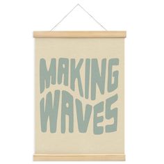 a sign that says making waves hanging on a wall with a wooden frame above it