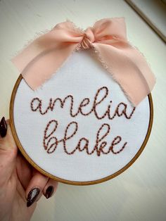 Looking for a fun, creative way to announce your baby's arrival? Or to gift someone special a unique, personalized item? Hand embroidered name hoops are a great way to add a personal touch to newborn photos or name/birth announcements that can double as nursery/room decor. They also make a nice gift for a sweet for a mama-to-be! - The pictured listing 'amelia blake' is a 5" stained wooden hoop on white fabric with pink writing. A light pink bow has been added to the hoop. PLEASE NOTE: Due to the Hand Embroidered Name, Light Pink Bow, Baby Name Announcement, Name Announcement, Birth Announcement Sign, Announcement Sign, Name Embroidery, Wooden Hoop, Nursery Room Decor