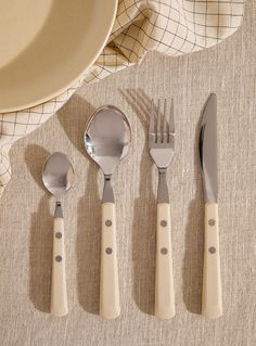 four forks, spoons and two knives on a table