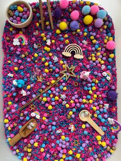 an assortment of crafting supplies are displayed on a surface with pom - poms