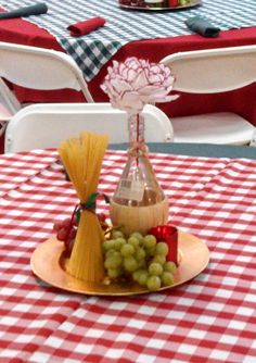 a table with red and white checkered tables cloths, wine bottle shaped like a cone