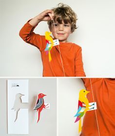 a boy is holding some paper birds in front of him