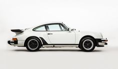 an old white porsche is parked on the floor