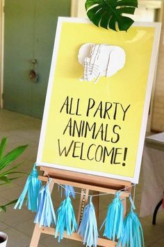 a sign that says, all party animals welcome with tassels hanging from it