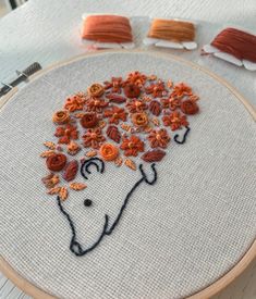 the embroidery is being worked on with scissors and thread