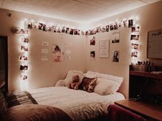 a bedroom with lights and pictures on the wall