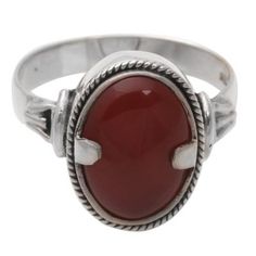 Twin prongs clasp a fiery carnelian in a silver embrace. Bright as a dragon's eye the gemstone centers a ring by Wayan Sarjana. Carnelian is believed to inspire action movement eloquence and courage; it fosters feelings of well-being. .925 Sterling silver Silver Carnelian Rings Spiritual Style, Silver Carnelian Spiritual Ring, Spiritual Carnelian Cabochon Rings, Spiritual Carnelian Ring Jewelry, Adjustable Silver Carnelian Rings, Silver Carnelian Ring, Single Stone Ring, Carnelian Ring, Dragon Eye