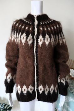 Amazing True Vintage Icelandic cardigan from the 1970s. Handknit from chunky, warm and soft Icelandic wool. Traditional yoke, lopapeysa pattern, off-white trims. Straight cut, crew neck. Beautiful folklore metal buttons. A timeless wardrobe piece in a natural color scheme. Handmade in Iceland! Looks great with a pair of jeans and hiking boots. BRAND: No brand label ERA: 1970s, 1980s COLOR: Dark brown, brown, off-white FABRIC: 100% pure Icelandic wool SIZE: Vintage size L, fits best women's size Icelandic Cardigan, Cozy Clothing, Timeless Wardrobe, Knit Cardigan Sweater, Chunky Wool, Brand Label, Brown Brown, Wool Knit, Cozy Outfit