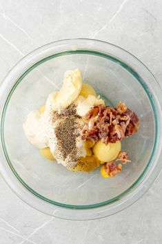 a glass bowl filled with food on top of a table