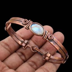 Natural Moonstone Cuff Bracelet Moonstone Bangle Moonstone Wire Wrapped Cuff Bracelet Wire Wrap Jewelry Copper Bangle Gemstone Cuff Bracelet Main Stone - Rainbow Moonstone Bangle Length - 2.50 - 2.75" Inches (Adjustable) Bangle Width  -  0.50 Inches Metal                  -  Copper Copper Has Been Used For Jewelry Making For Thousands Of Years, Dating Back To Ancient Civilizations Such As The Egyptians, Romans, And Aztecs. Copper Was Valued For Its Beauty, Versatility, And Durability, And Was Of Spiritual Moonstone Bangle Jewelry, Spiritual Moonstone Bangle, Moonstone Gemstone Cuff Bracelet Bangle, Adjustable Moonstone Bohemian Cuff Bracelet, Adjustable Moonstone Bangle Bracelet, Moonstone Cuff Bracelet Bangle As A Gift, Handmade Moonstone Cuff Bracelet Bangle, Gemstone Cuff Bracelet, Bijoux Fil Aluminium