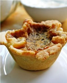 two small pies sitting on top of a white plate