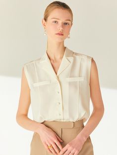 Editor's NoteThis blouse features a chest pocket detail and a notched collar in a classic mood. The fabric is a thick chiffon fabric, providing a solid and firm fit without significant sheerness.- Upper part of the collar is made of satin fabric that matches the color of the blouse- Sleeveless design is layered fabric detail and a shallow armhole line, making it comfortable to wear without worrying about exposure- Verstaile item that goes great with skirts, trousers, jeans, and more Measurements (In.)1/2- Total Length: 24.57 in. / 24.84 in.- Shoulder: 15.79 in. / 16.30 in. - Chest: 36.97 in. / 38.98 in.- Waist: 35.94 in. / 37.95 in.- Hem: 40 in. / 42.01 in.Composition & Care- Upper: 100% Polyester - Lining: 100% Polyester - 60% Rayon 40% Polyester- Dry clean only*Model info: MARTY Classic V-neck Tops With Pockets, Elegant Fitted Blouse With Pockets, Elegant Tops With Pockets And Lapel Collar, Elegant Fitted Tops With Pockets, Elegant Collared Tops With Welt Pockets, Chic Daywear Blouse With Pockets, Chic Blouse With Pockets For Daywear, Elegant Formal Blouse With Pockets, Semi-formal Sleeveless Top For Spring