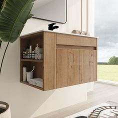 a bathroom with a large mirror and wooden cabinet in the corner next to a plant