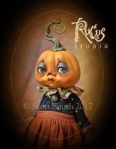 a pumpkin doll with an evil look on it's face