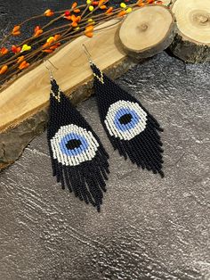 Earrings from beads from the evil eye. Earrings with fringes. Earrings with a blue eye. Made from Czech beads. Length 5.5 inches (14 cm). Width 1.5 inches (4 cm). Hypoallergenic clasp. If you want these earrings in a different color, write to me and I will be happy to make them for you. Beaded Evil Eye Earrings, Seed Beading, Evil Eye Earrings, Beaded Earrings Patterns, Earrings Beaded, Blue Evil Eye, Eye Earrings, Blue Eye, Earrings Drop