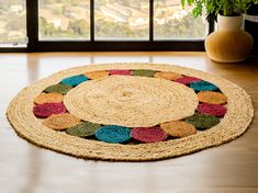 a round rug with multicolored circles on the floor in front of a window