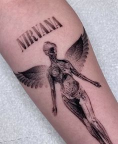 a tattoo on the arm of a man with an image of a woman and wings