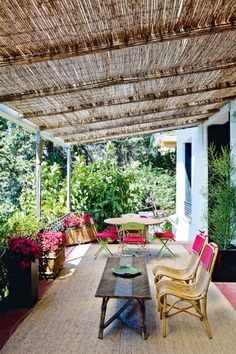 an outdoor covered patio with wicker furniture