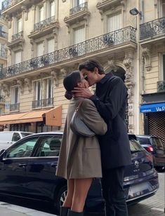 a man and woman kissing on the street