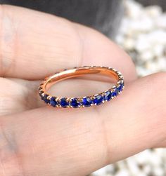 Full Eternity Band Ring with Natural Royal Blue Sapphires. MaterialSolid Gold (14K & 18K) or PLATINUM 950 FinishingHigh Polished/ Shiny PlatingOnly if WHITE GOLD - Rhodium/ Platinum Family FitComfort/ Rounded Width2.3 mm Height2 mm Setting TypePave StoneNatural Blue Sapphire QualityAAA Shape & CutRound, Diamond Cut Stone Size2 mm Quantity of Stones: apx 32 Sapphire's Rich Deep Mystic Royal Blue looks absolutely stunning! This Band is full of Elegance and Beauty. These bands make a great Blue Sapphire Eternity Band As Gift, Blue Gemstone Eternity Band In Fine Jewelry Style, Blue Round Eternity Band With Prong Setting, Blue Sapphire Eternity Band For Promise Ring, Blue Round Eternity Band For Anniversary, Blue Sapphire Eternity Band With Prong Setting, Blue Half Eternity Round Ring, Blue Round Cut Eternity Band For Anniversary, Blue Round Cut Eternity Band