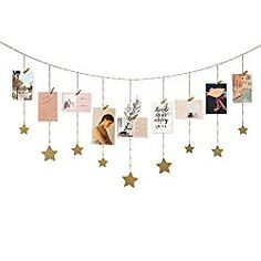 a string with pictures hanging from it and stars attached to the strings, all in gold