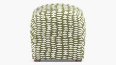 a green and white patterned ottoman