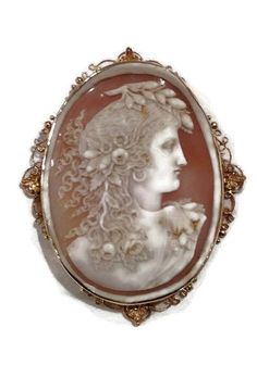 Magnificent That is the only word to describe this outstanding pin/pendnat. The cameo is ornately hand carved with no chips or breaks. The cameo depicts a woman with long flowing hair with flowers. The entire pin including frame measures approximately 4 inches! The cameo is from the late 1800's however I believe the 14 karat yellow gold frame was made slightly later...perhaps around the early to mid 1900's. On the back of the frame the pendant attachment can be swiveled down so as not to be seen Hair With Flowers, Antique Amethyst Ring, Amethyst Ring Vintage, Victorian Cameo, Seed Pearl Ring, Flowing Hair, Cameo Jewelry, Vintage Cameo, Carved Shell