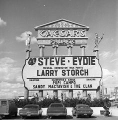 cars are parked in front of a large sign