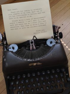 an old - fashioned typewriter with a note attached to it