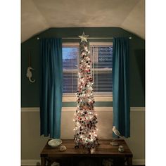 a decorated christmas tree in the corner of a room