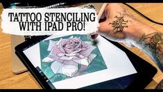 a person with tattoos on their arm is using an ipad to draw a tattoo design