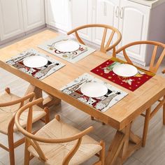 the table is set with place mats and chairs for four people to sit at it