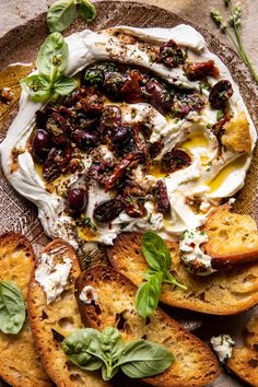 a plate with bread, cheese and herbs on it