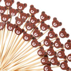 a bunch of brown teddy bears on top of toothpicks in the shape of hearts