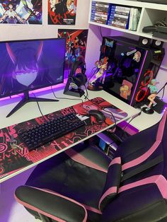 a computer desk with a keyboard, mouse and monitor on it in front of some anime posters