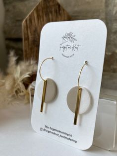 the earrings are on display in front of a card